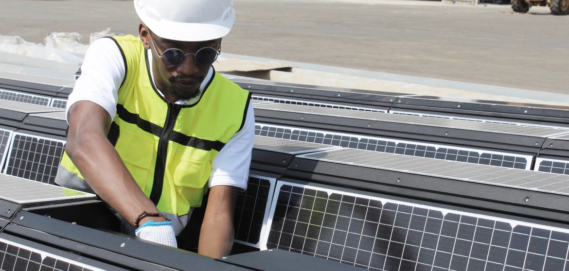 A man from EnGoPlanet solar street light maintenance service working on a solar street light